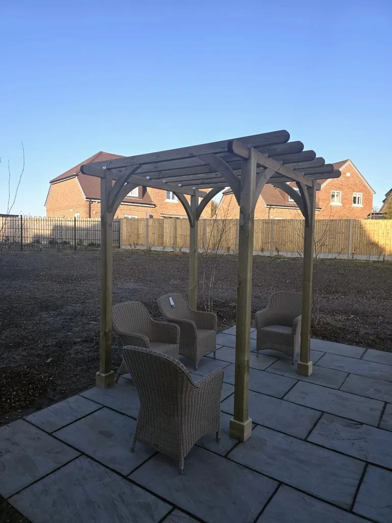 Freestanding wooden pergola over patio area with outdoor seating furniture